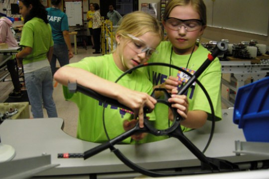 Kids looking at car parts