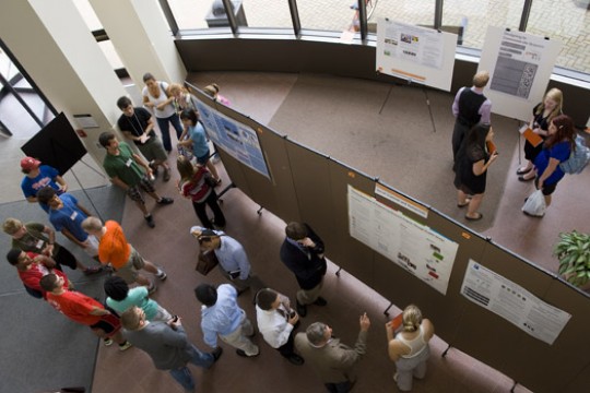 People gathered around displays at event