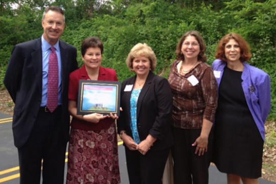 People gathered with award