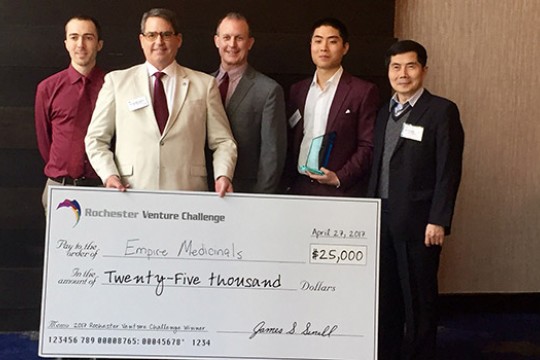 People posing with giant check