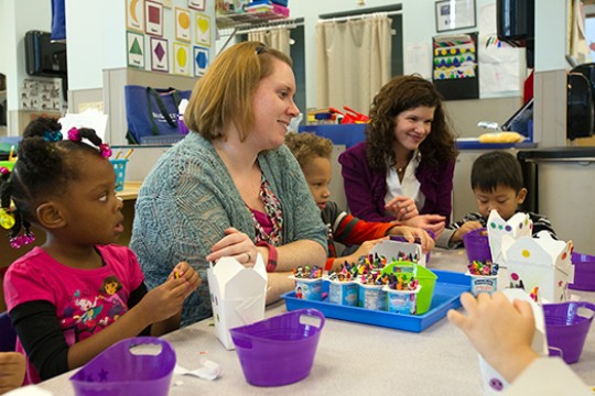People teaching children in classroom