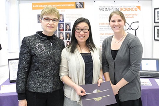 People posing infront of display 