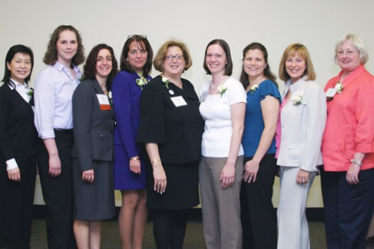 people posing in front of whiteboard