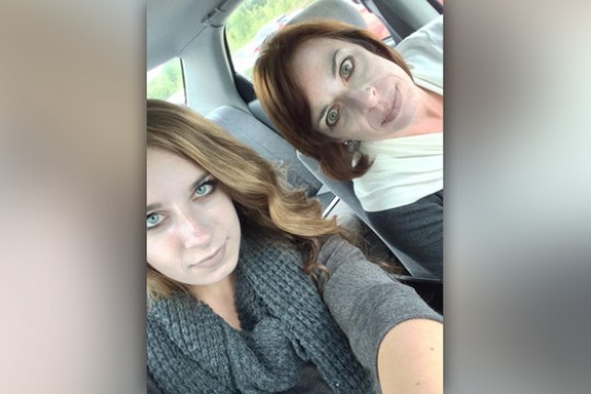 People posing for camera in car