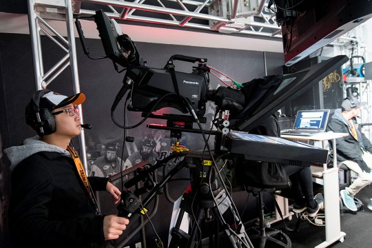 Student operates camera with teleprompter