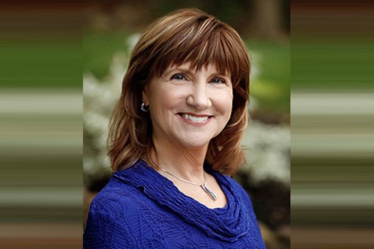 Head-and-shoulders view of woman in blue sweater 