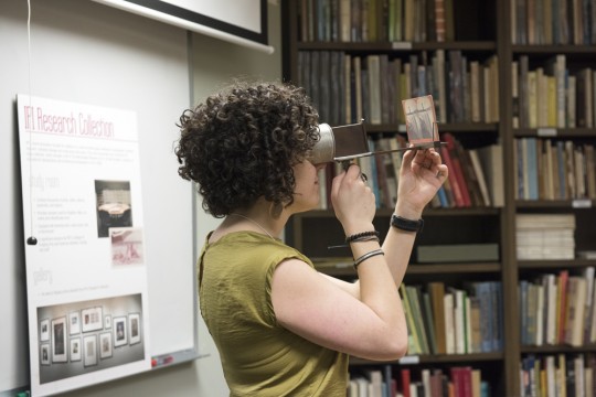 An IPI visitor examines a photograph.