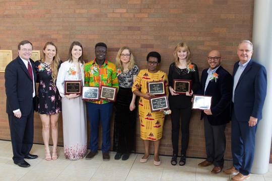 Group shot of several students holding awards.