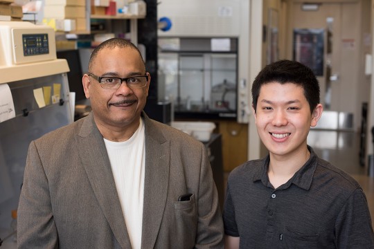 Faculty member and student pose together.