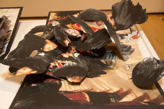 Pop-up book with several overlapping flaps of woman's face and long, black hair.