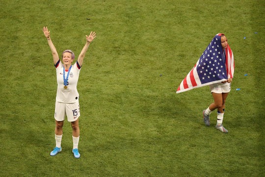 Two femle soccer players celebrate victory.