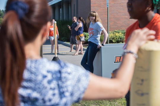 Students help new students move in.
