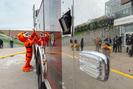 Tiger mascot looks at firetruck