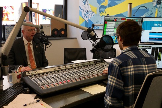 President Munson talking to student in radio station.