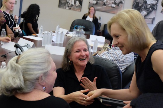 three women meeting and shaking hands.