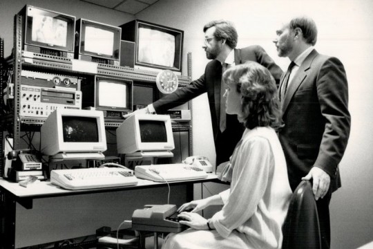In 1988, three Canadian Captioning Development Agency employees watch television monitors in a studio where closed captioning is done.