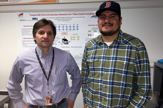 professor and student in front of poster presentation.