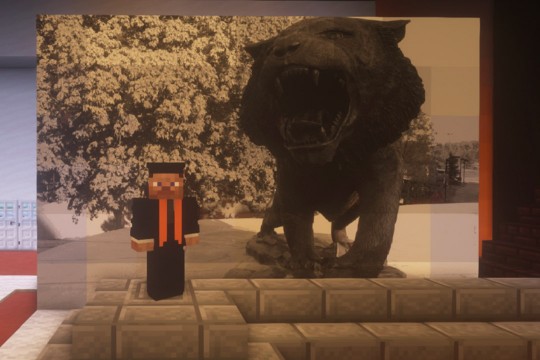 Minecraft character posing next to photo of tiger statue.