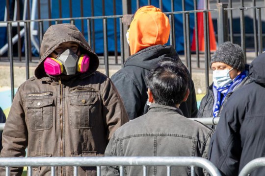 crowd of people wearing different types of face masks.