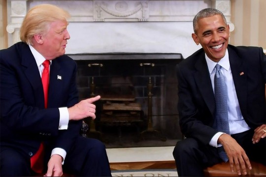 Trump and Obama sit next to each other.