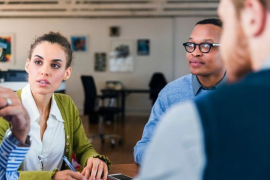 three people sitting at business meeting.
