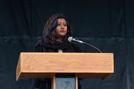woman speaking at a podium.