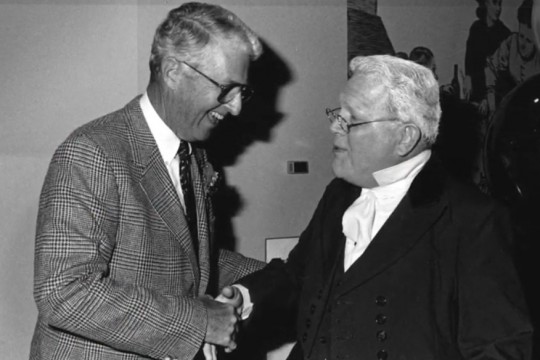 black-and-white photo of two men shaking hands.