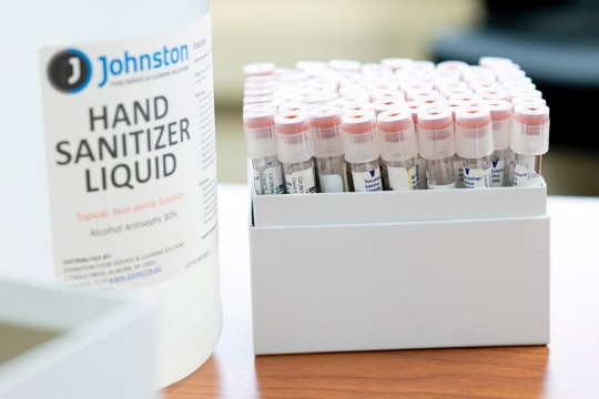 bottle of hand sanitizer and box od vials.