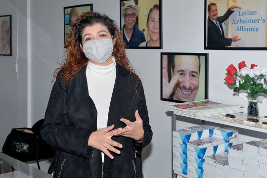 woman wearing a fask mask standing in an office building.