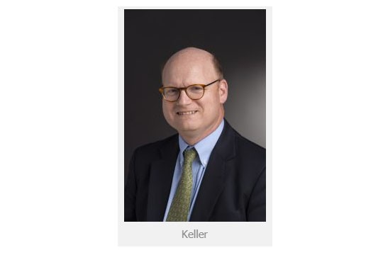 Man with glasses in suit and tie. 