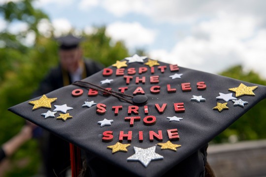 graduation cap that reads: despite the obstacles, strive to shine.