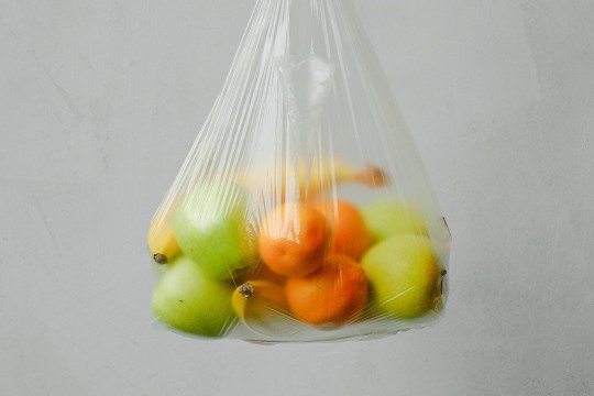 clear plastic bag of apples, pears, bananas, and oranges.