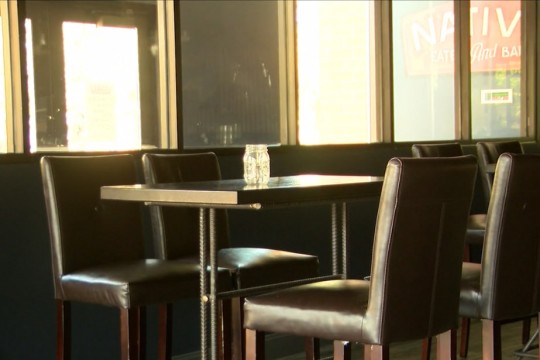 empty table and chairs at a restaurant.