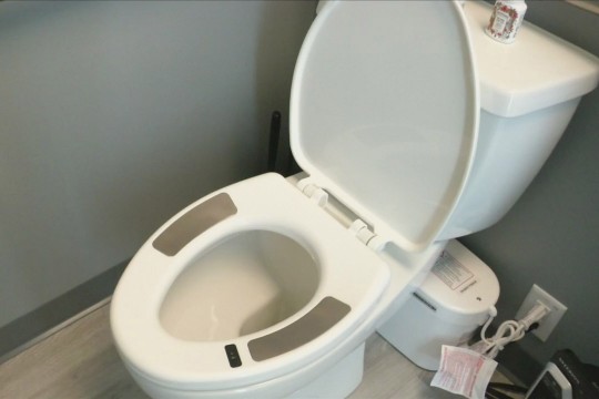 toilet with seat with sensors on it.