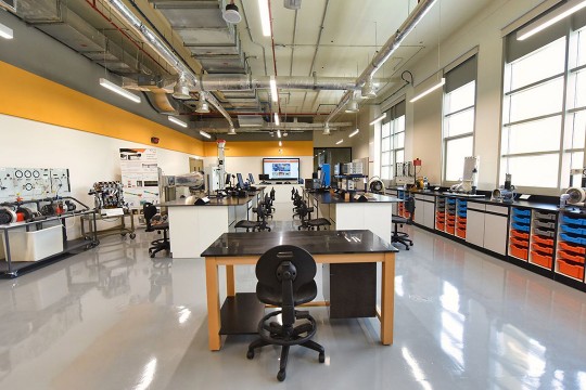 lab with tables, chairs, computer equipment and engineering equipment.
