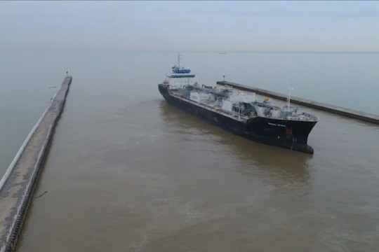 cargo ship leaving a port.