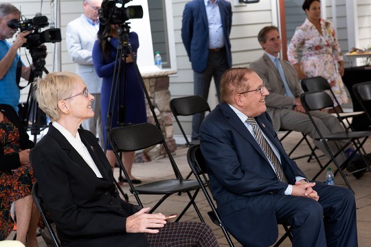 man and woman sitting in folding chairs.