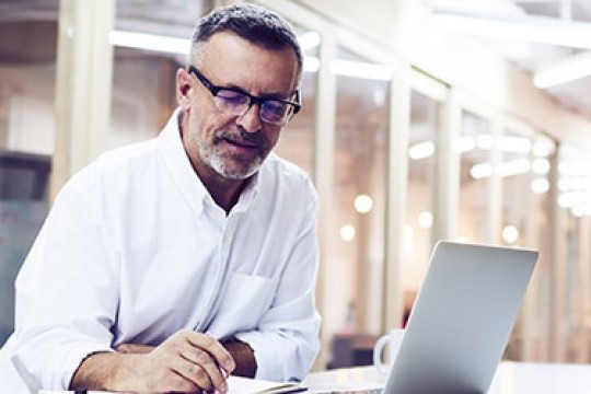man working on a laptop computer.