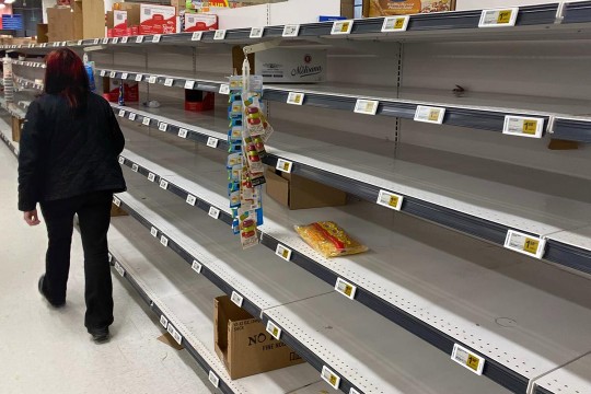 grocery store shelves with very few products on them.