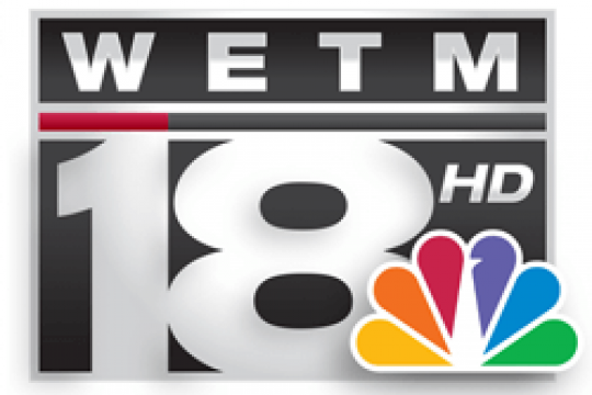 WETM TV 18 Elmira logo with with the CNBC rainbow peacock logo in the lower right corner