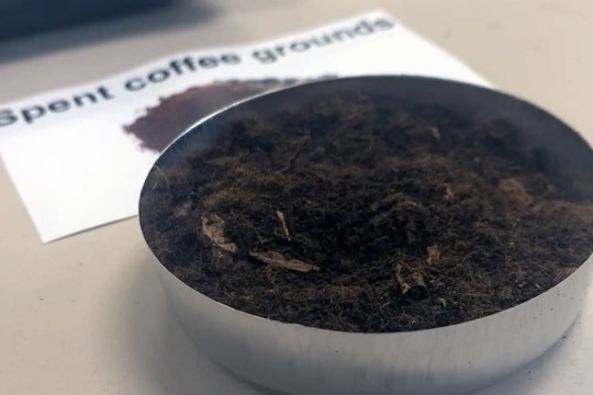 dish of spent coffee grounds.