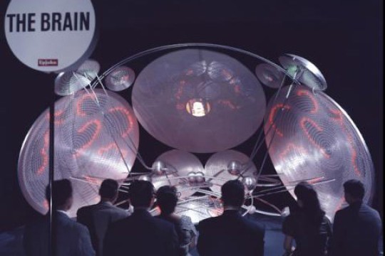 artwork with large disks and spheres.