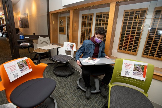 student trying out new chairs for a clasroom.