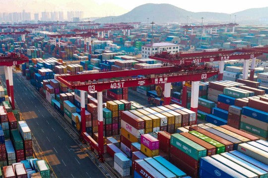 shipping containers stacked at a port in China.