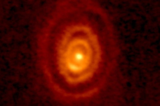 Three rings of ejected gas sail away from an aging star.