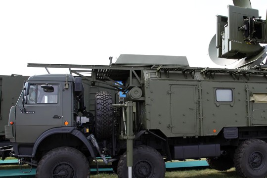 a military vehicle with a satellite dish on it.