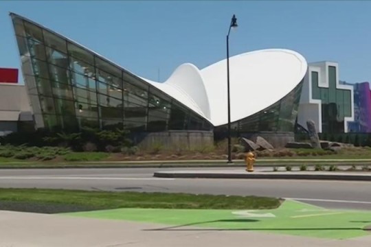 exterior view of glass building resembling butterfly wings.
