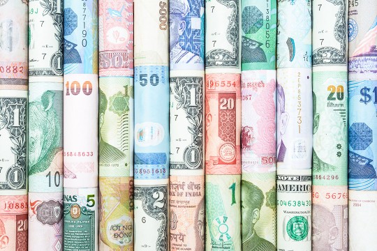 series of rolls of paper money from different countries.