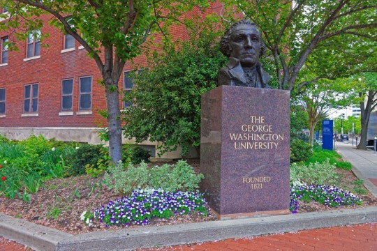 bust of George Washington on a marble stone engraved with The George Washington University, founded in 1821.