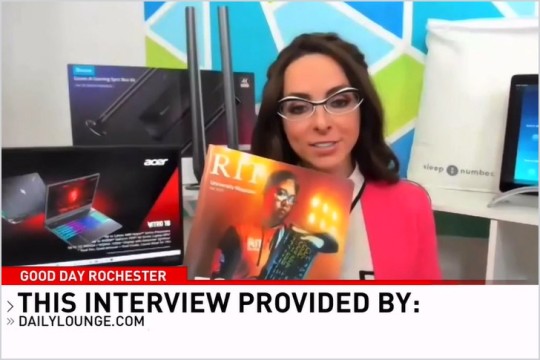 TV personality holding up an awesome RIT University Magazine.